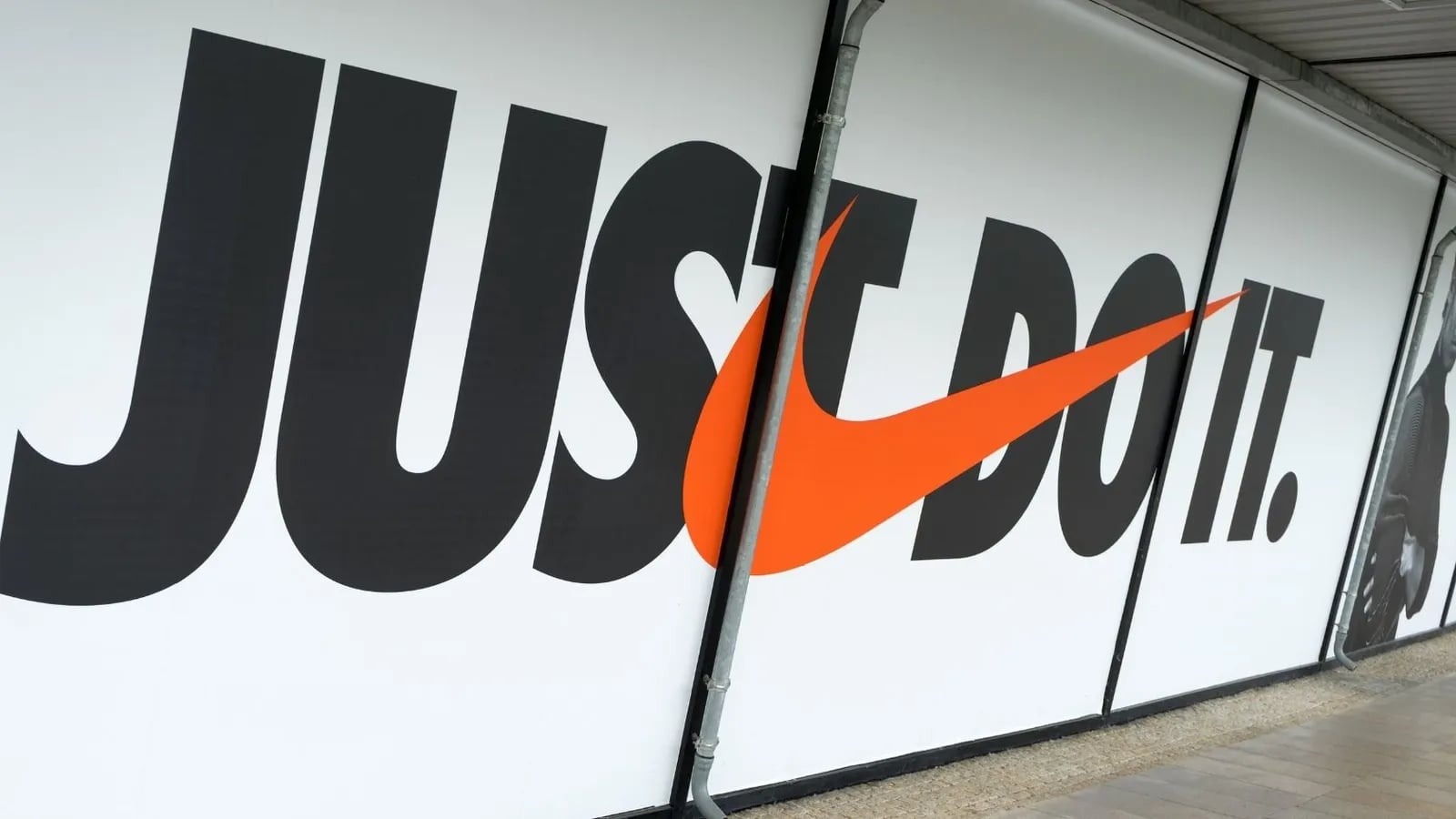 A large Just Do It mural with the Nike swoosh.