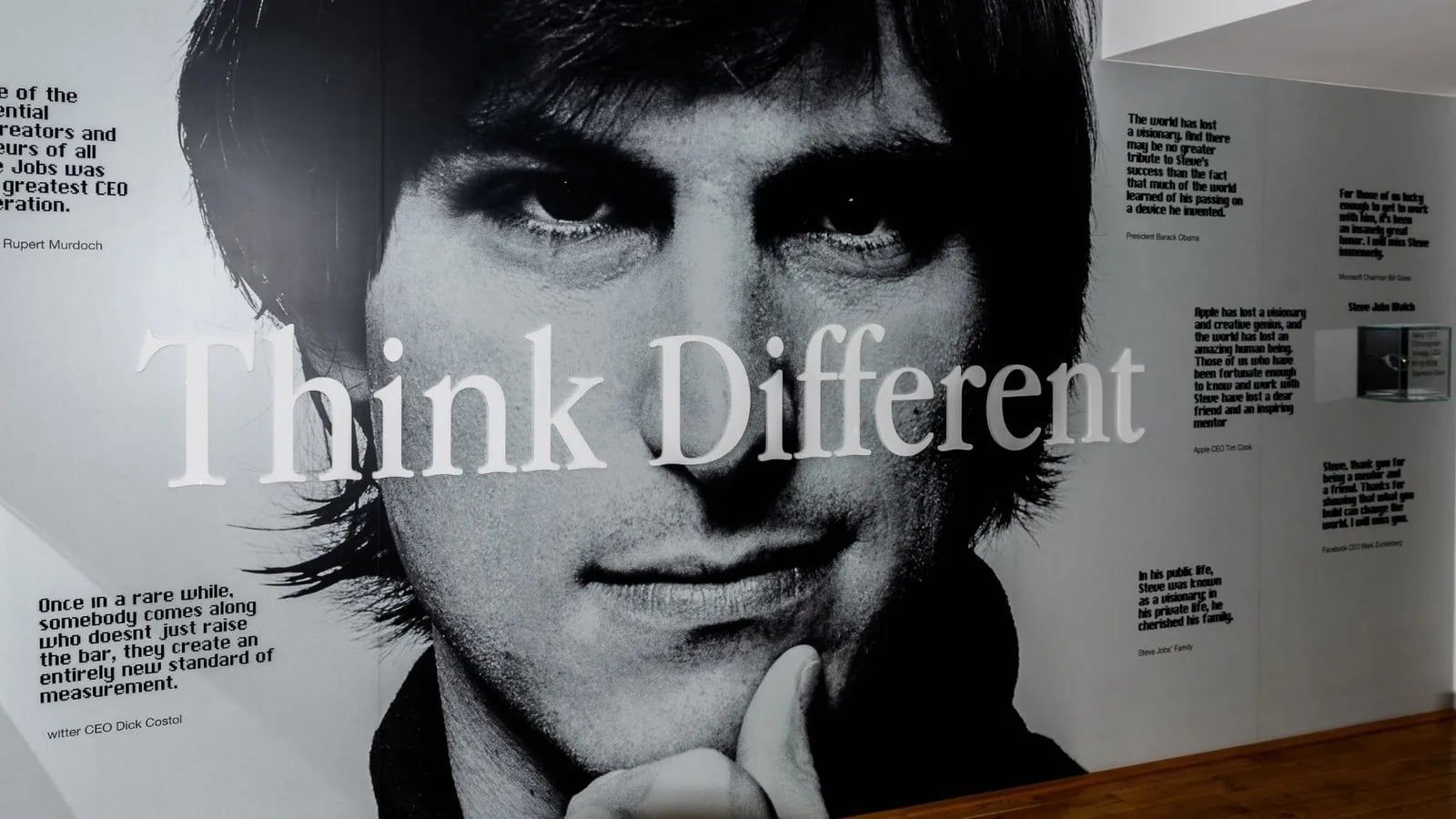 A black and white Think Different poster featuring a famous face.